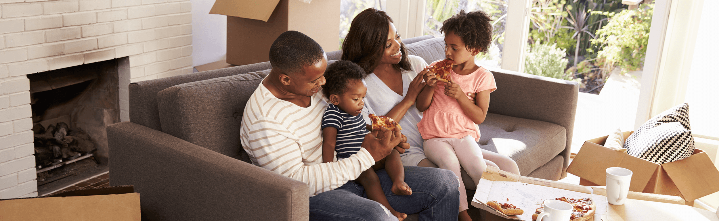 Family enjoying a Greco Pizza